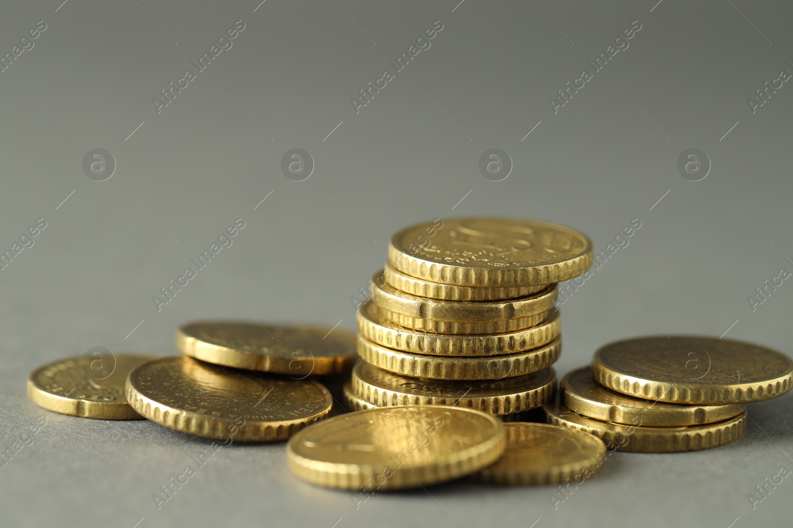 Photo of Many euro coins on grey background, closeup