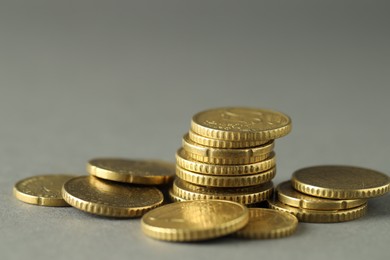 Photo of Many euro coins on grey background, closeup