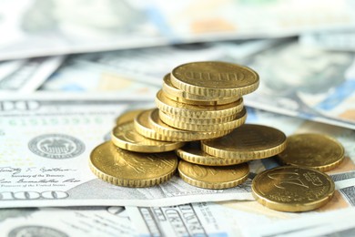 Photo of Many euro coins on dollar banknotes, closeup