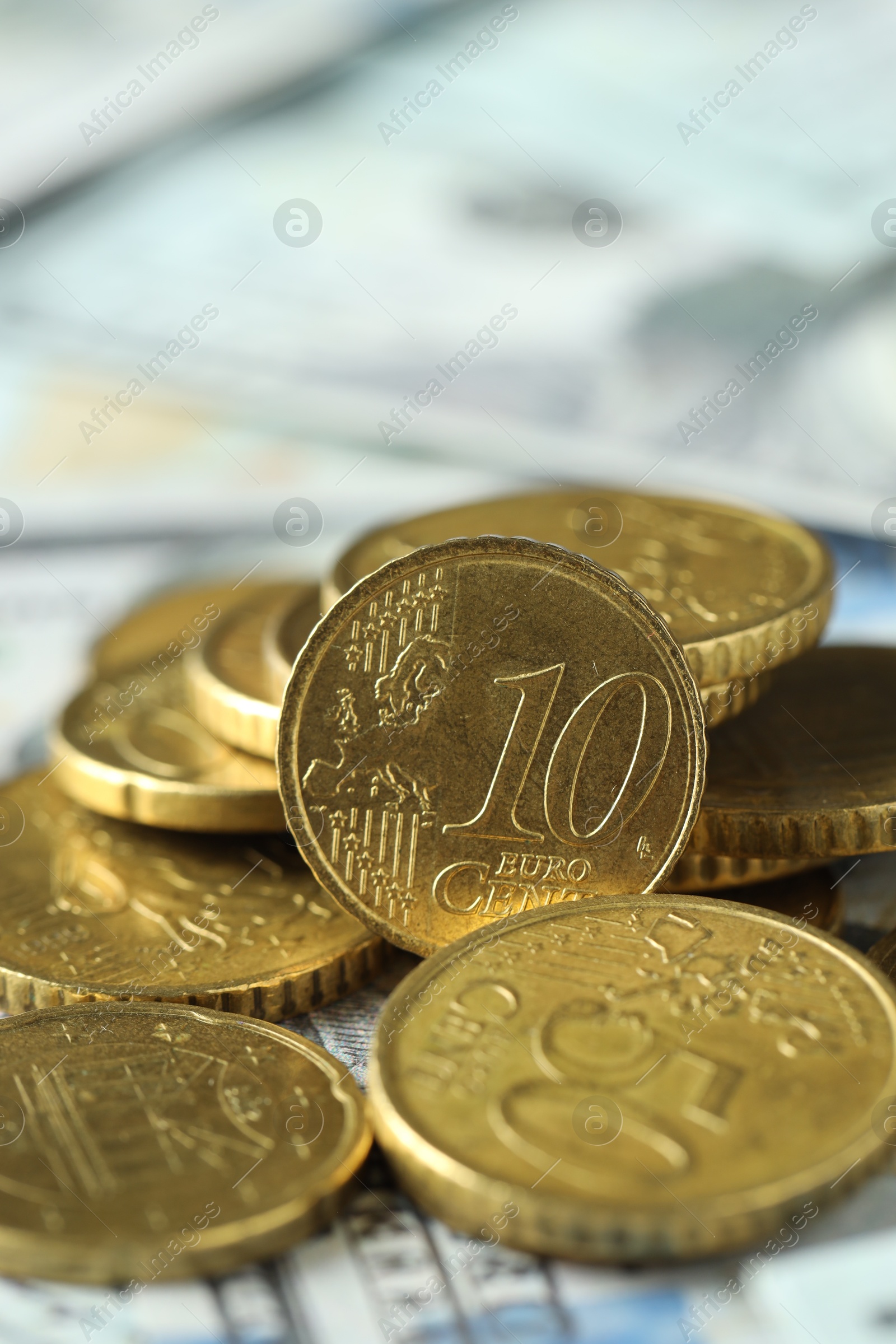 Photo of Many euro coins on dollar banknotes, closeup