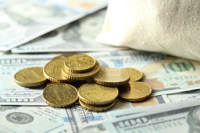 Photo of Many euro coins on dollar banknotes, closeup