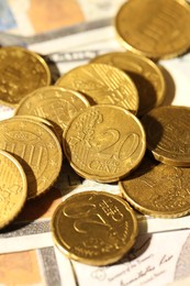 Photo of Many euro coins on dollar banknotes, closeup