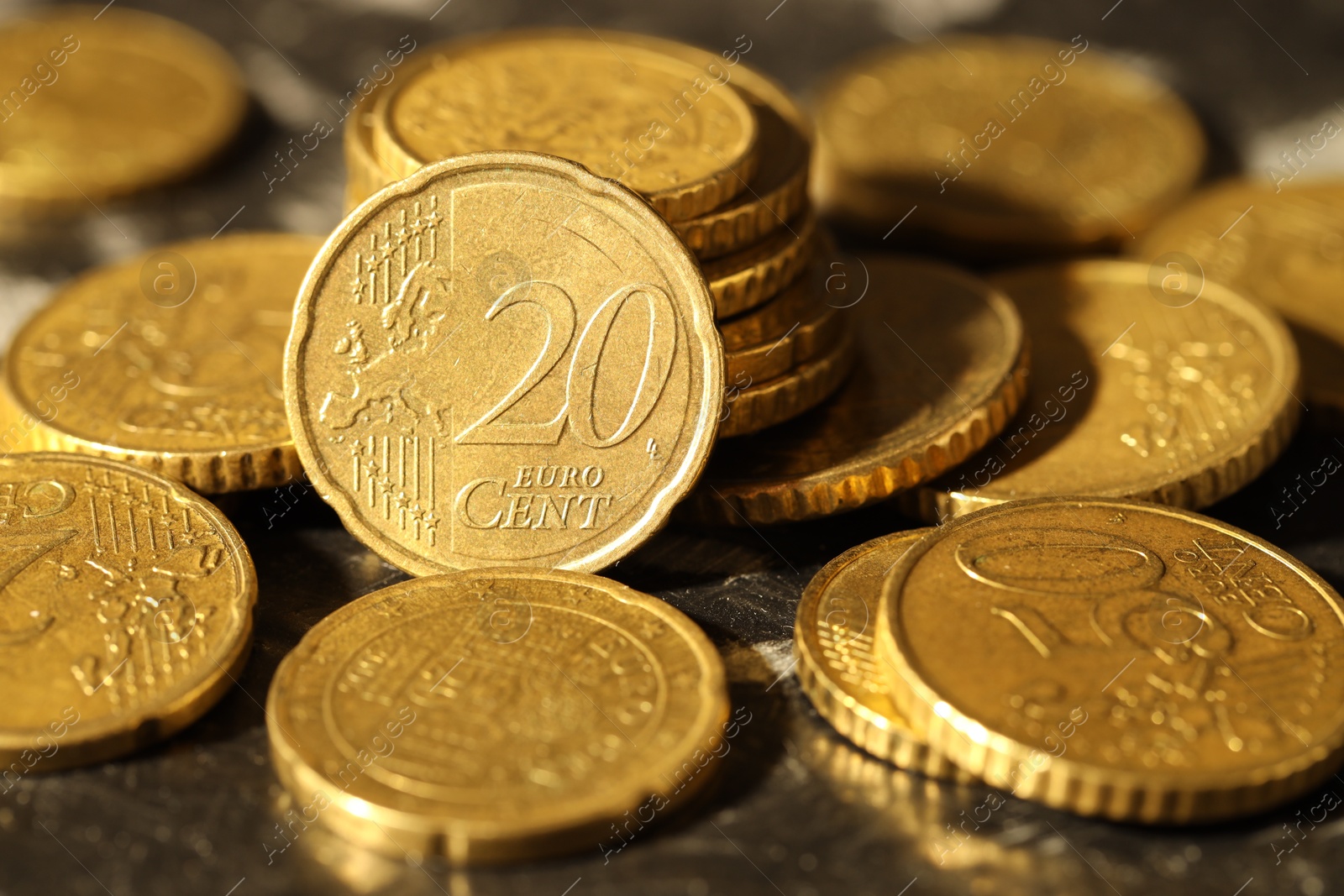 Photo of Many euro coins on dark table, closeup