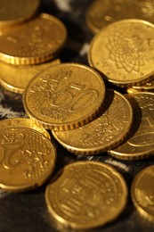 Photo of Many euro coins on dark table, closeup