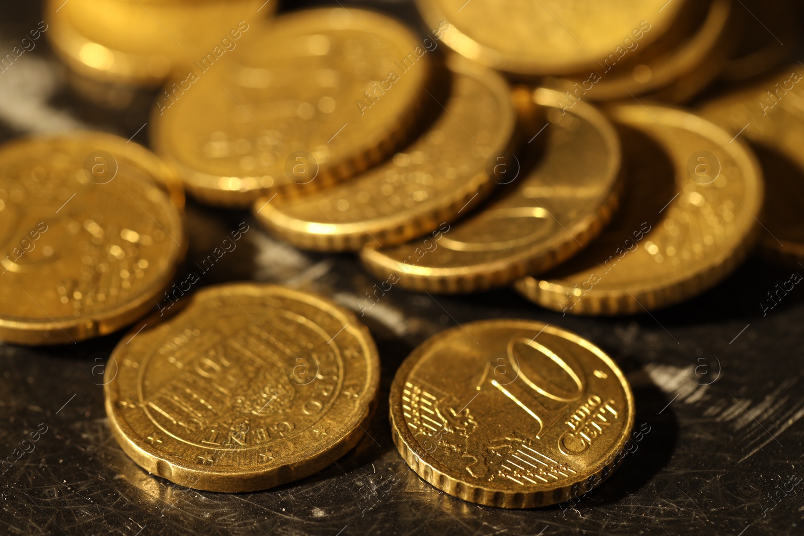 Photo of Many euro coins on dark table, closeup