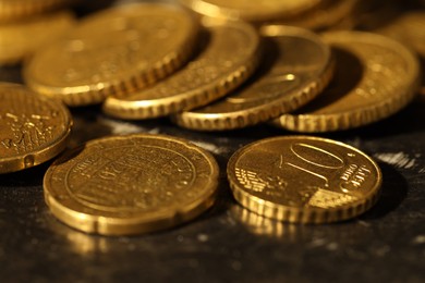 Photo of Many euro coins on dark table, closeup