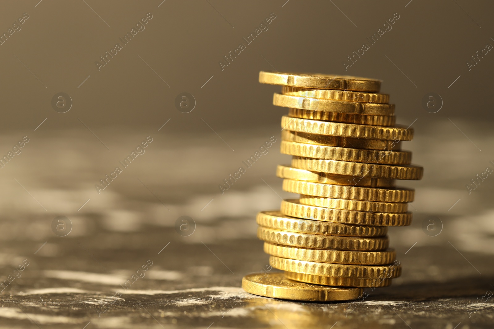 Photo of Stacked euro coins on dark table, space for text