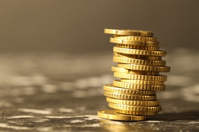 Photo of Stacked euro coins on dark table, space for text