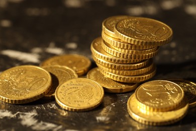 Photo of Many euro coins on dark table, closeup