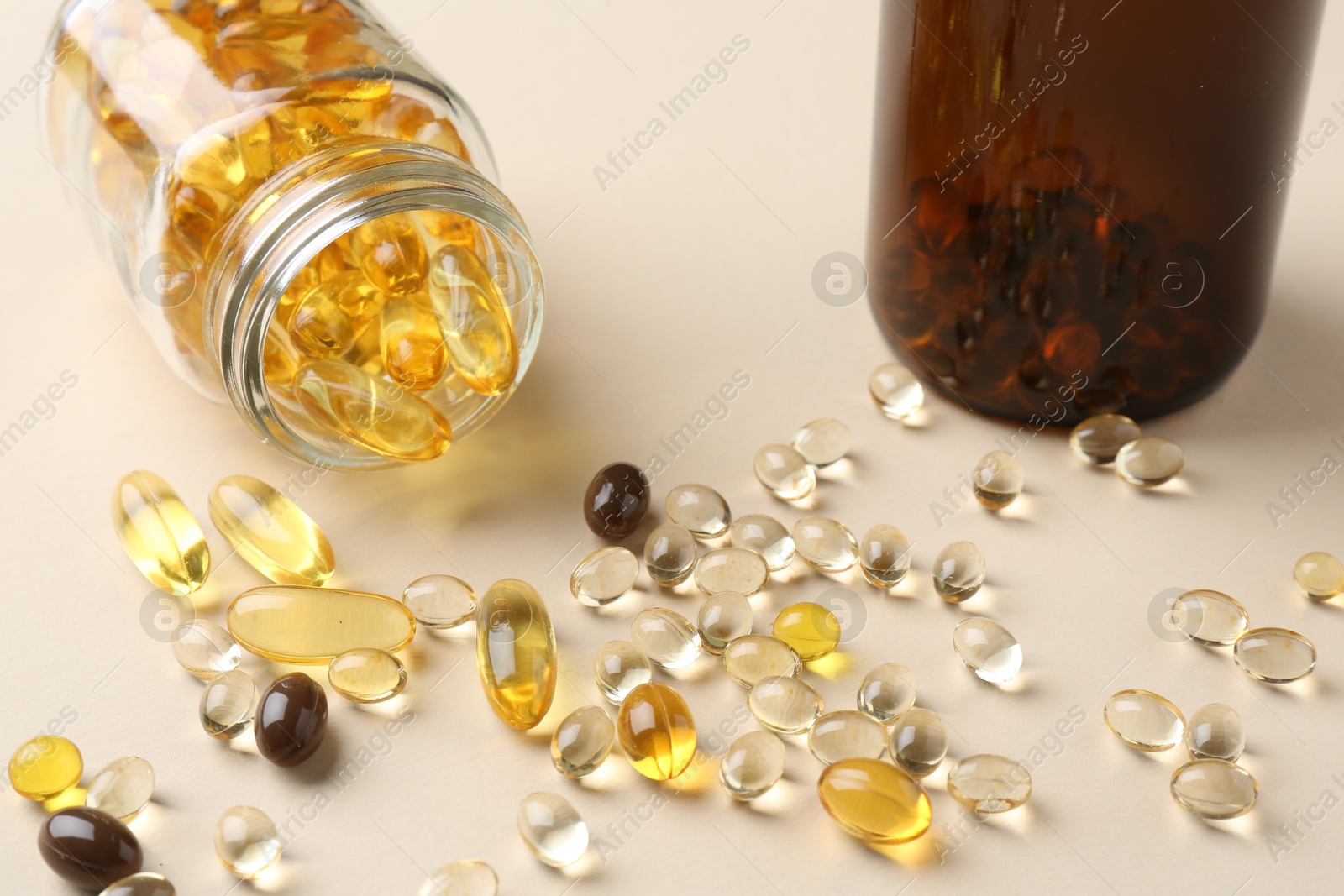 Photo of Pharmacist. Many different pills and overturned bottle on beige background, closeup