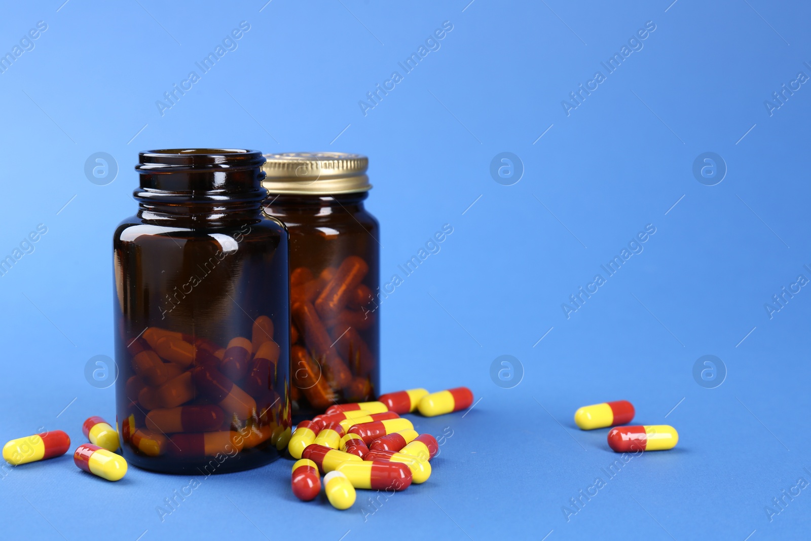 Photo of Pharmacist. Pills in plastic bottles on blue background