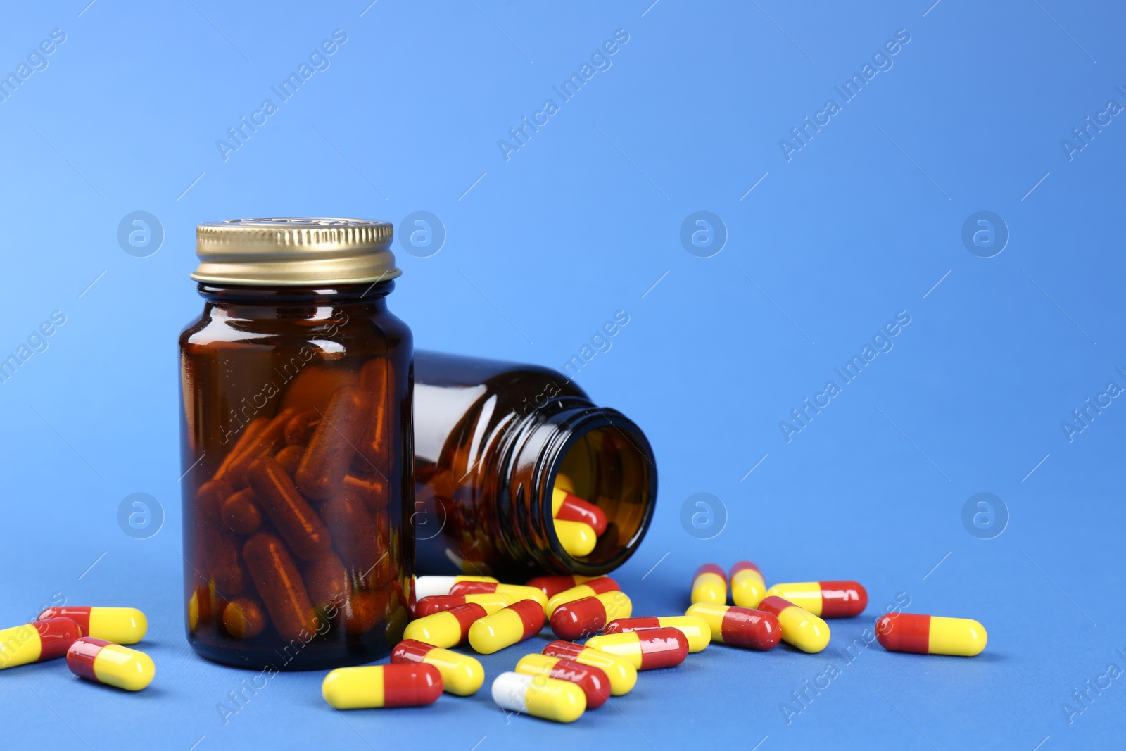 Photo of Pharmacist. Pills in plastic bottles on blue background