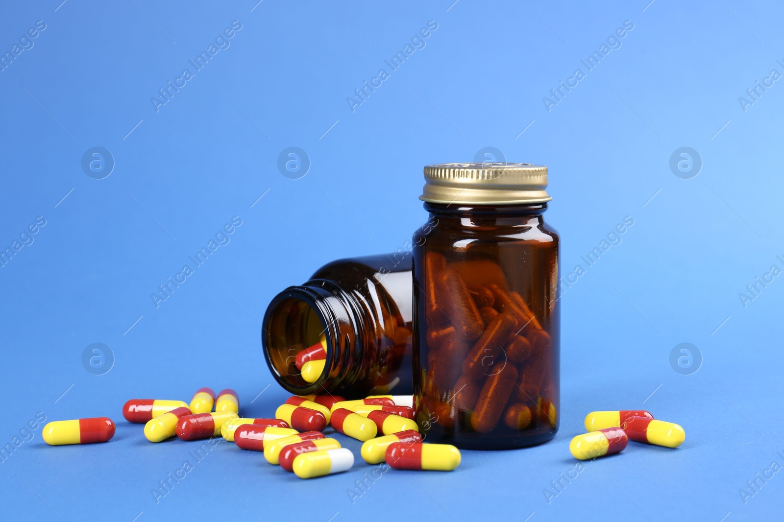 Photo of Pharmacist. Pills in plastic bottles on blue background