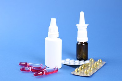 Pharmacist. Bottles of medical drops, pills and ampoules on blue background