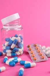 Photo of Pharmacist. Many different pills on pink background