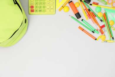 Photo of Backpack and different school supplies on light gray background, flat lay. Space for text