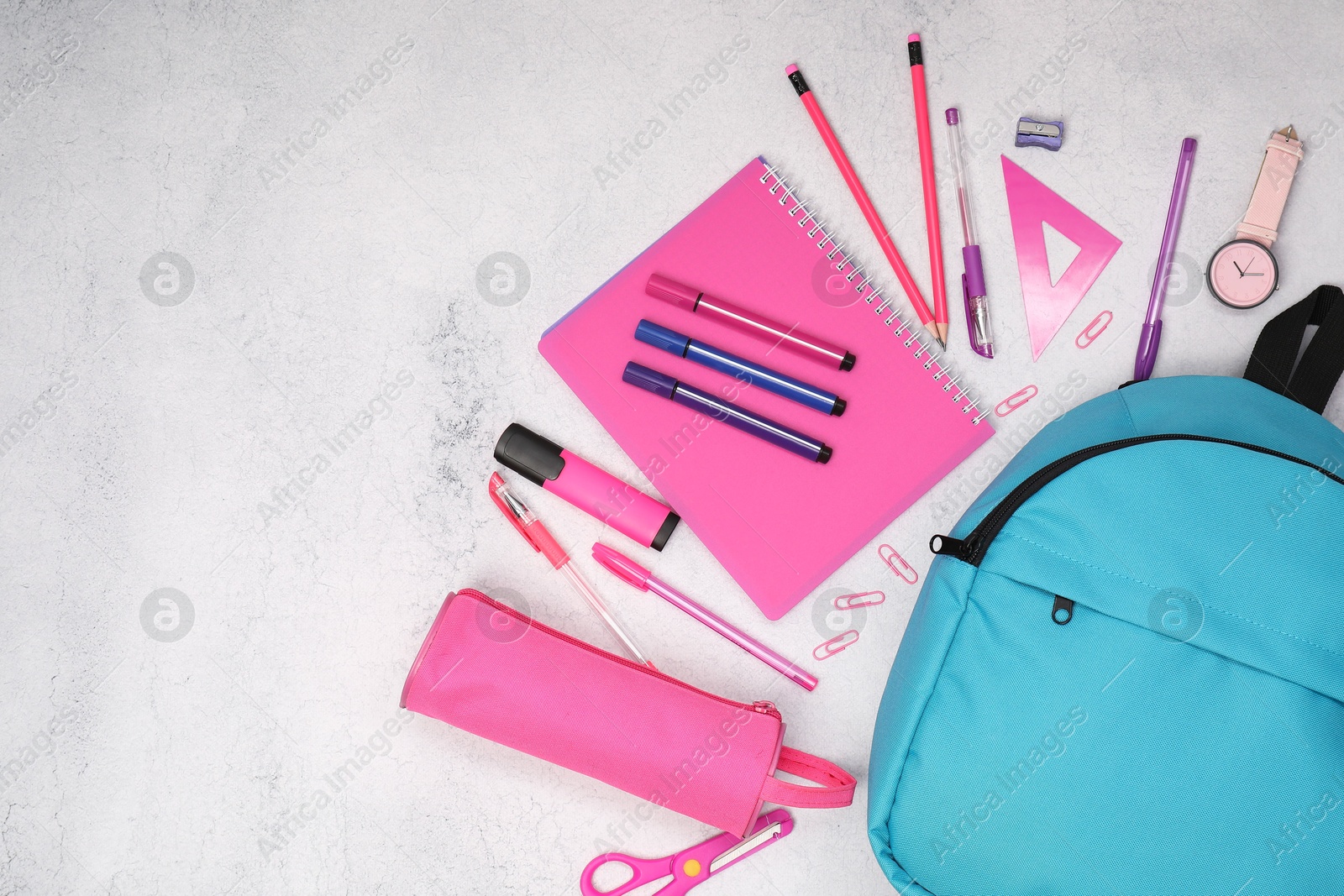 Photo of Flat lay composition with backpack and different school stationery on light grey table, space for text