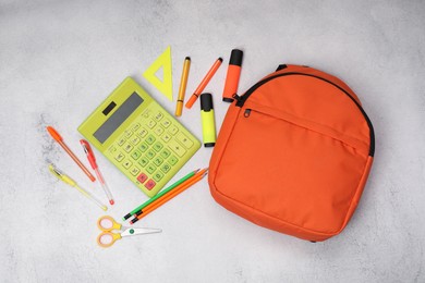 Photo of Flat lay composition with backpack and different school stationery on light grey table