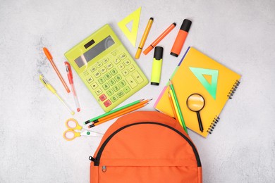 Photo of Flat lay composition with backpack and different school stationery on light grey table