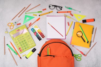 Photo of Flat lay composition with backpack and different school stationery on light grey table