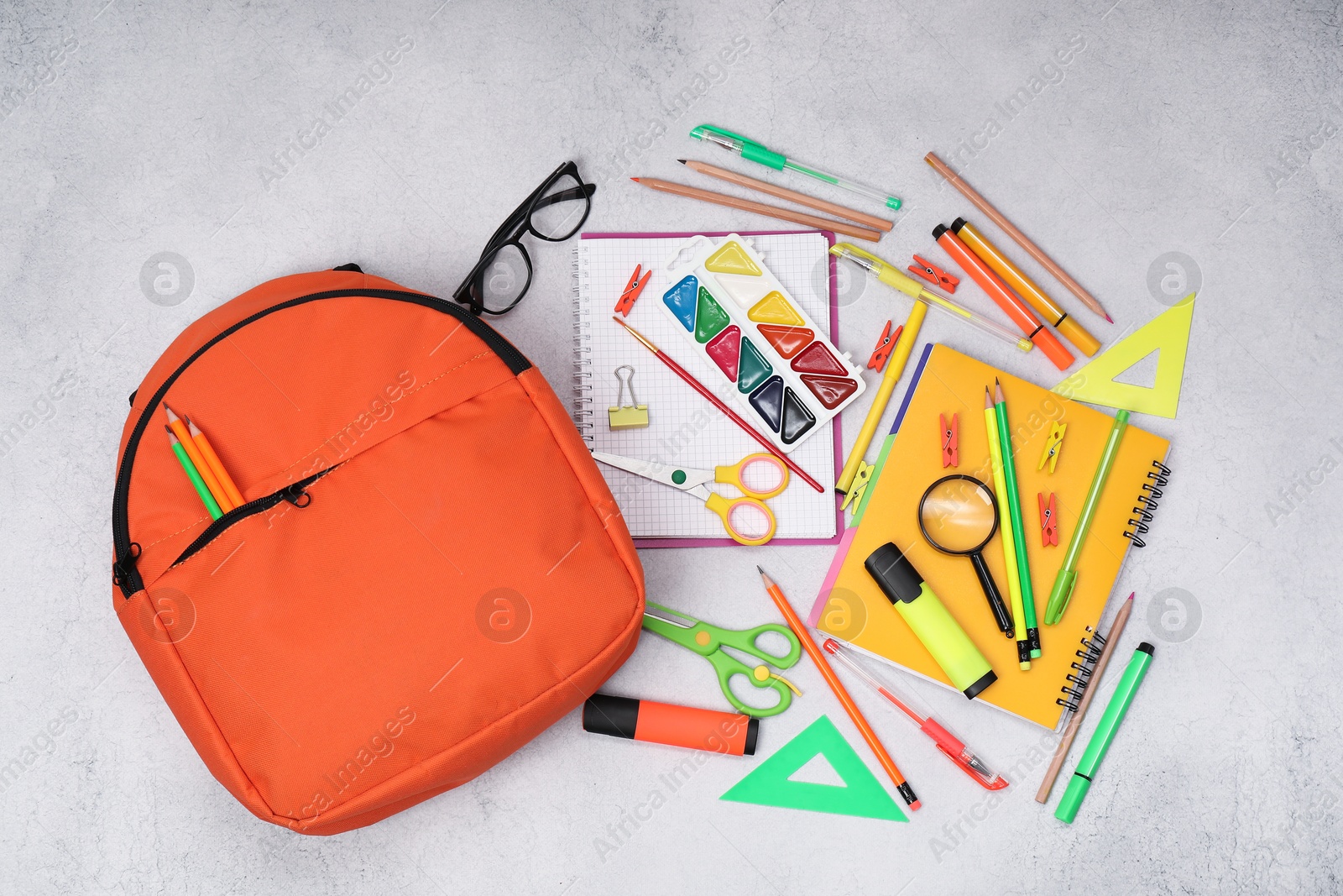 Photo of Flat lay composition with backpack and different school stationery on light grey table