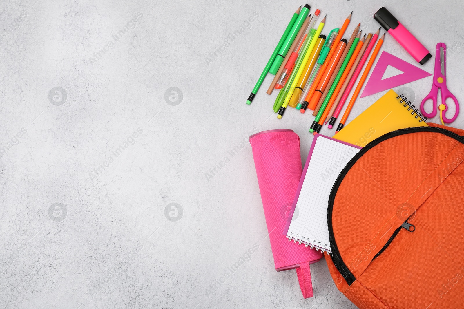 Photo of Flat lay composition with backpack and different school stationery on light grey table, space for text