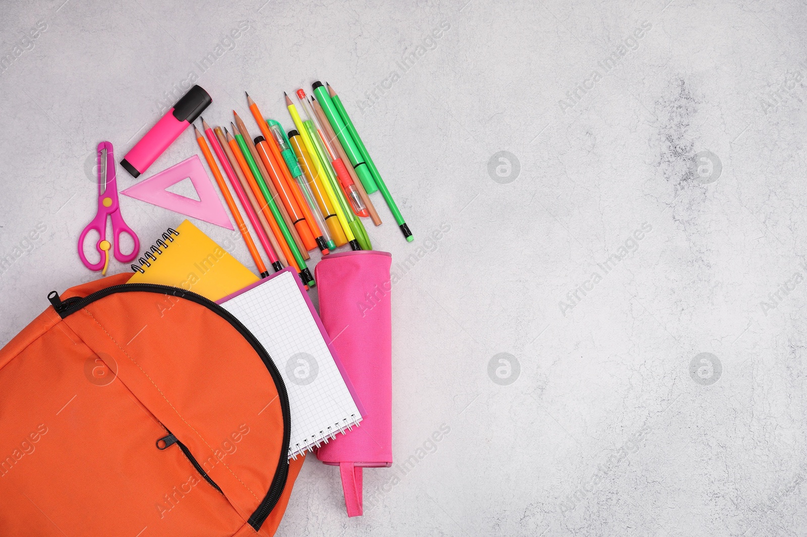 Photo of Flat lay composition with backpack and different school stationery on light grey table, space for text