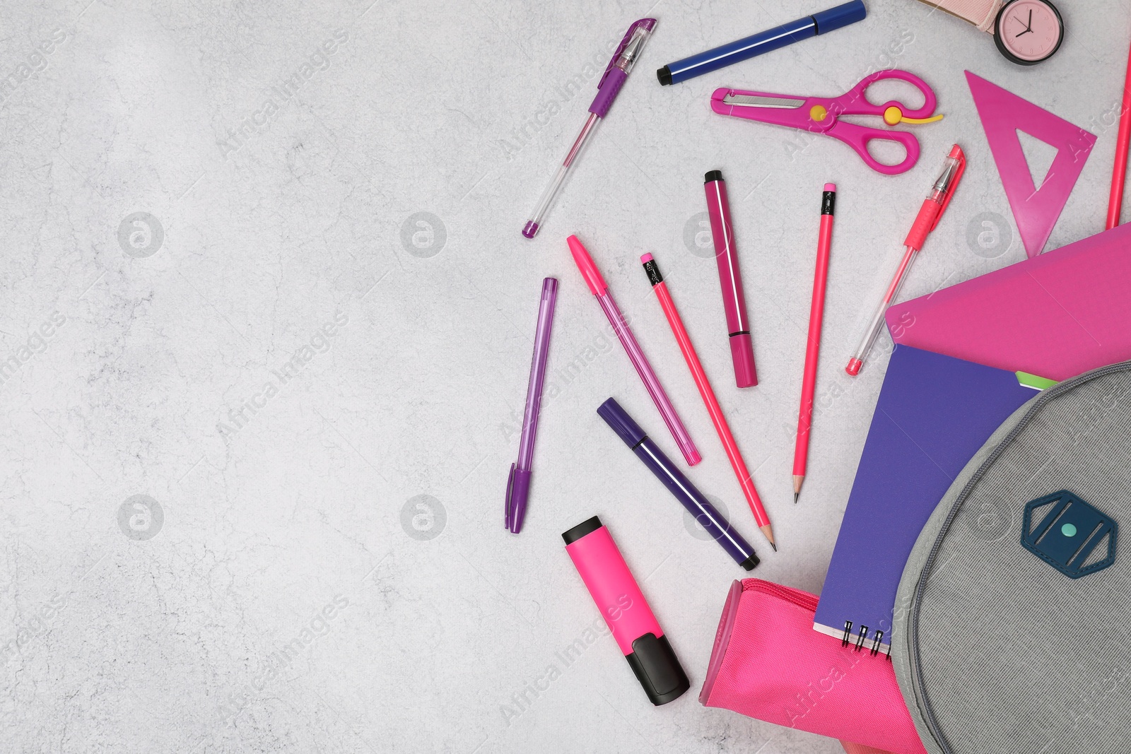 Photo of Flat lay composition with backpack and different school stationery on light grey table, space for text