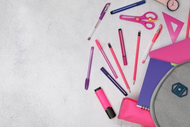 Photo of Flat lay composition with backpack and different school stationery on light grey table, space for text