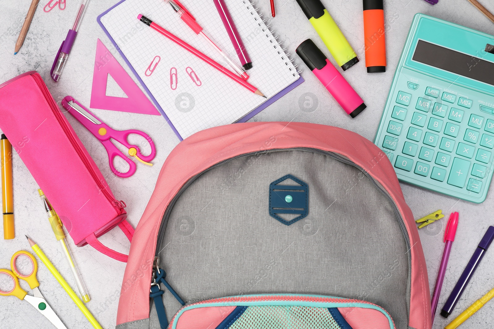 Photo of Flat lay composition with backpack and different school stationery on light grey table