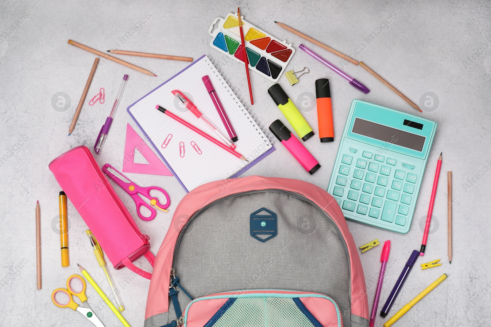 Photo of Flat lay composition with backpack and different school stationery on light grey table