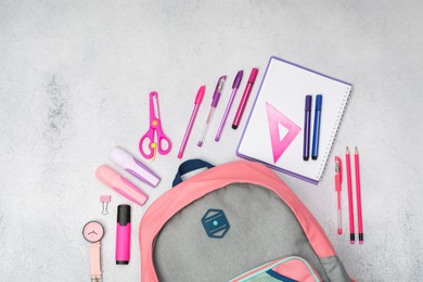 Photo of Flat lay composition with backpack and different school stationery on light grey table