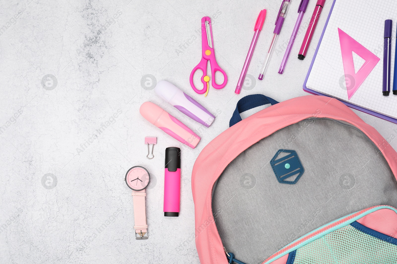 Photo of Flat lay composition with backpack and different school stationery on light grey table, space for text