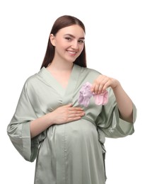 Photo of Expecting twins. Pregnant woman holding two pairs of socks on white background