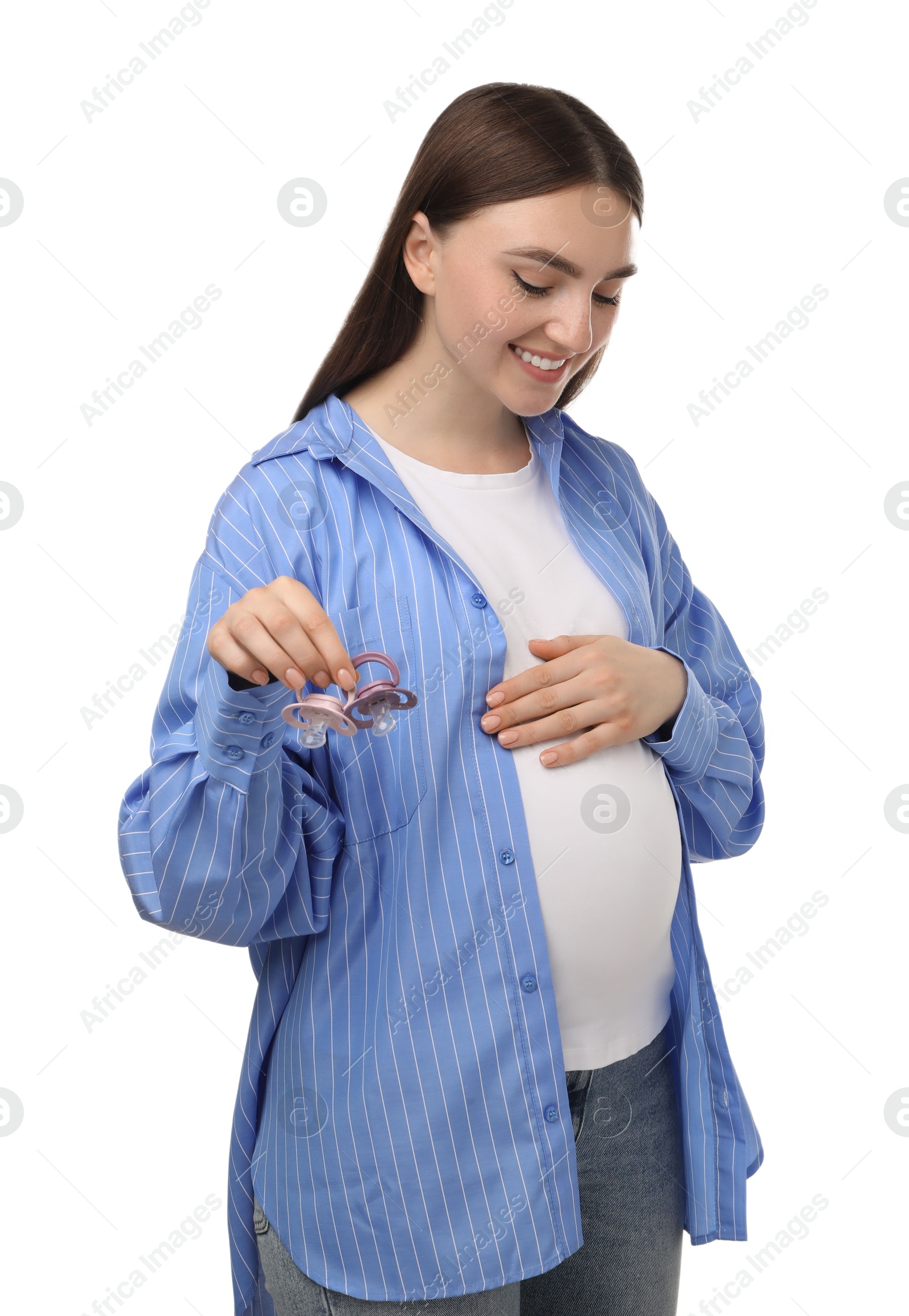 Photo of Expecting twins. Pregnant woman holding two pacifiers on white background