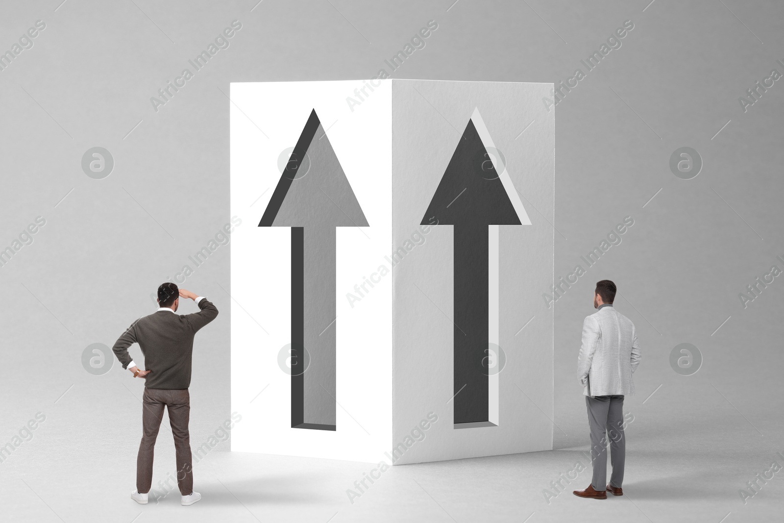 Image of Small men standing in front of huge arrows on grey background. Concept of career growth