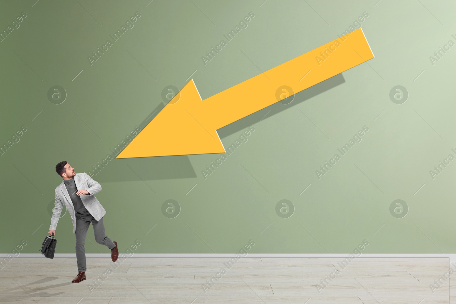 Image of Small businessman running away from huge arrow on light green background. Concepts of responsibility, problems