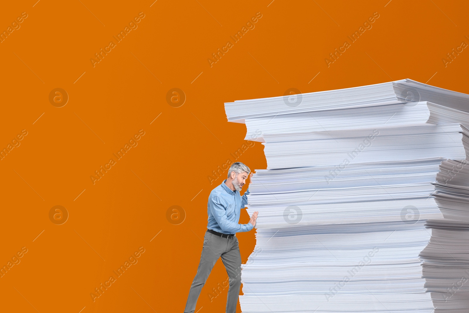 Image of Small man pushing huge stack of papers on orange background, space for text. Concepts of workload, deadline, overworking