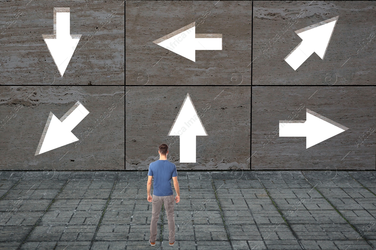 Image of Small man looking at wall with arrows pointing in different directions. Concept of choice