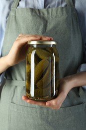 Photo of Woman with jar of tasty pickled cucumbers, closeup