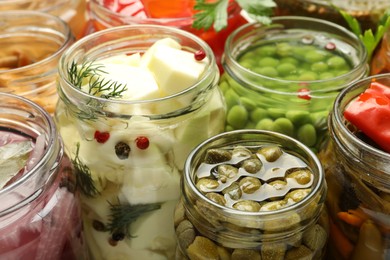 Photo of Different pickled products in jars, closeup view