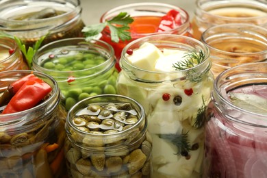 Different pickled products in jars, closeup view