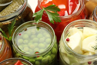 Photo of Different pickled products in jars, closeup view