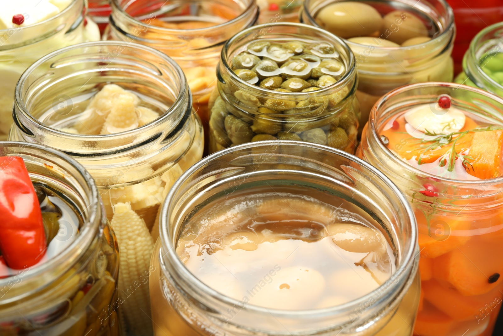 Photo of Different pickled products in jars, closeup view