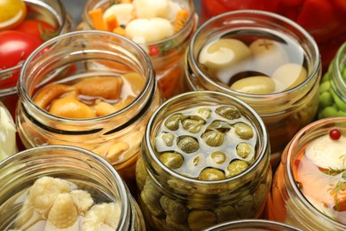 Photo of Different pickled products in jars, closeup view