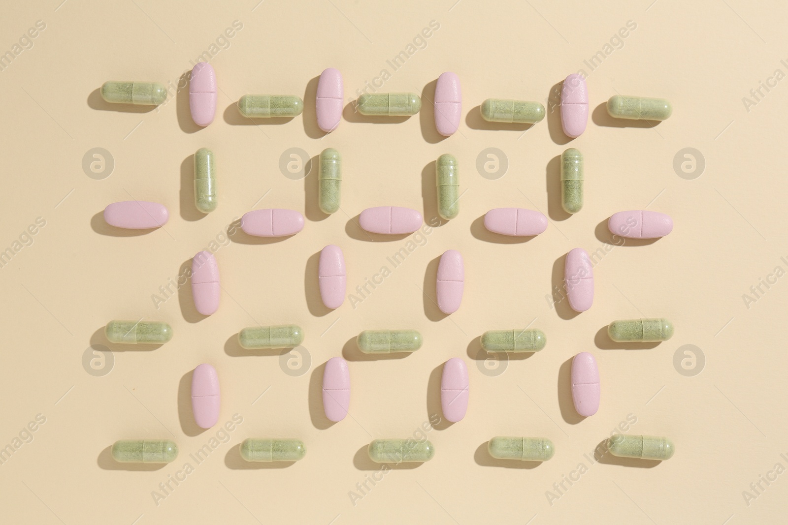 Photo of Pharmacist concept. Many different pills on beige background, flat lay