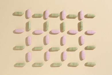 Pharmacist concept. Many different pills on beige background, flat lay