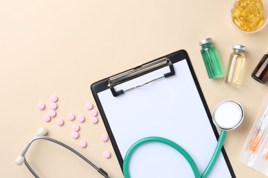 Pharmacist concept. Flat lay composition with clipboard, stethoscope and pills on beige background, space for text