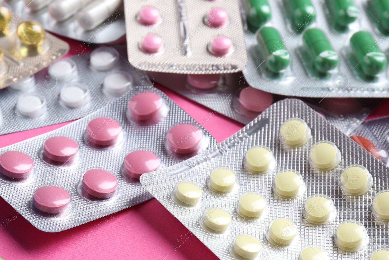 Photo of Pharmacist concept. Many different pills on pink background, closeup