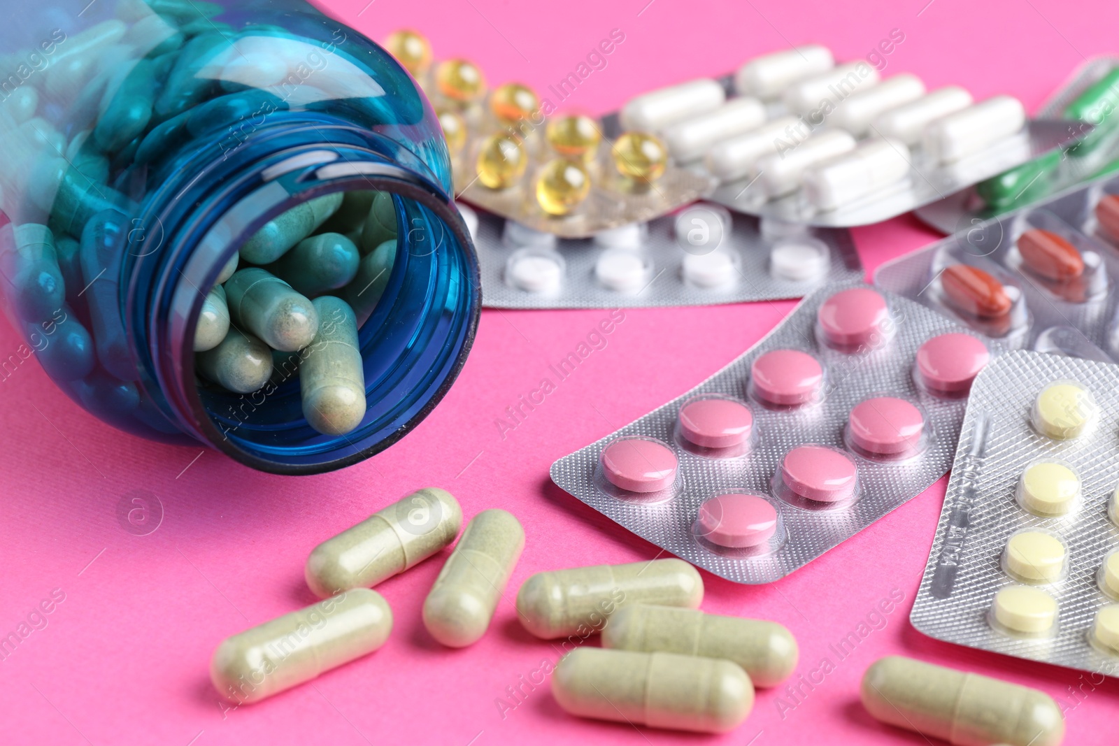 Photo of Pharmacist concept. Many different pills on pink background, closeup